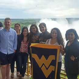 Students holding a WVU flag